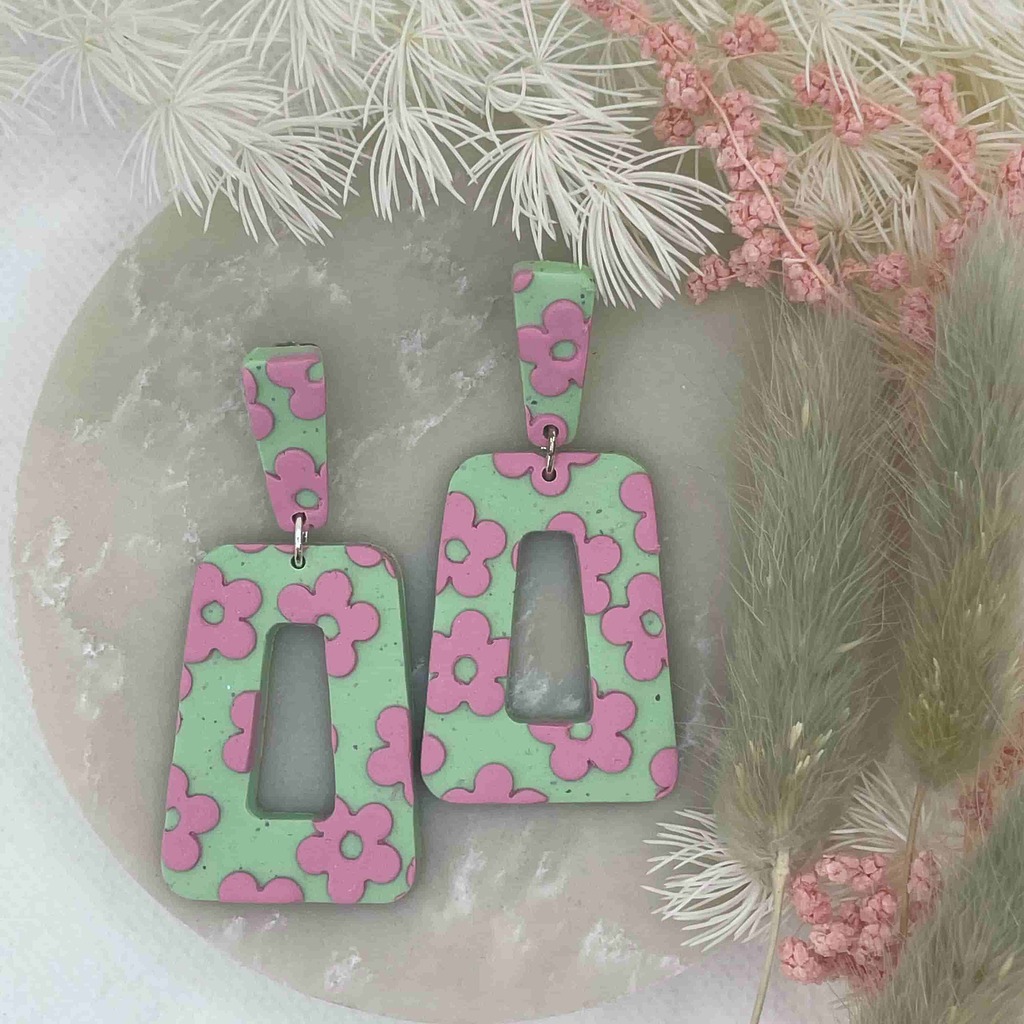 green shaped earrings with pink daisies